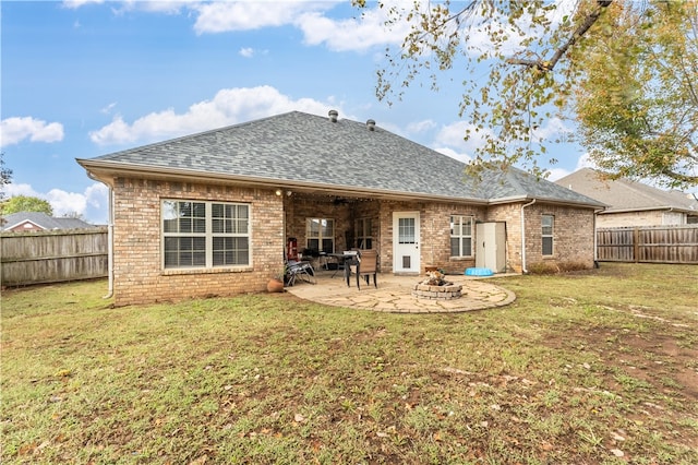 rear view of house with a yard and a patio area