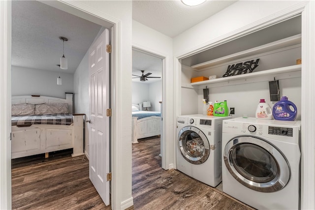 clothes washing area with dark hardwood / wood-style floors, ceiling fan, a textured ceiling, and washer and dryer