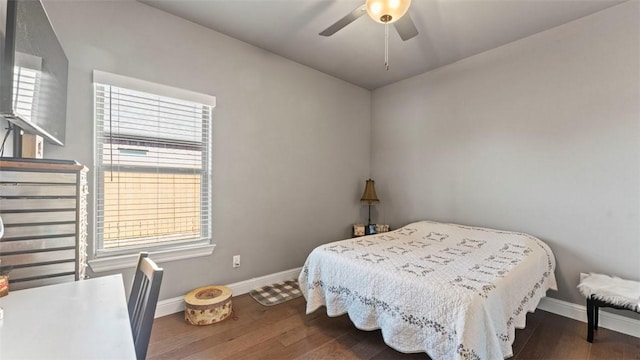 bedroom with ceiling fan, dark wood-style flooring, and baseboards