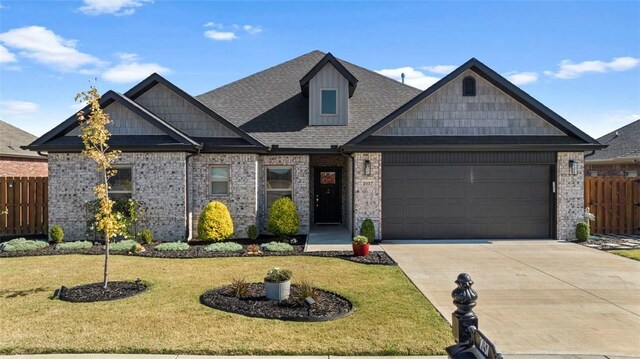 view of front of property featuring a front yard and a garage