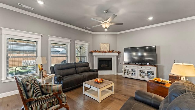 living room featuring dark wood-type flooring, visible vents, and crown molding