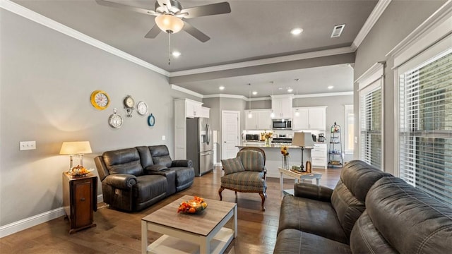 living room with recessed lighting, wood finished floors, visible vents, baseboards, and crown molding