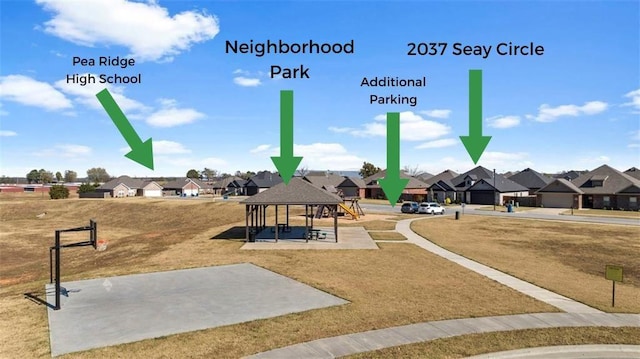 view of community featuring a residential view, a lawn, and a gazebo