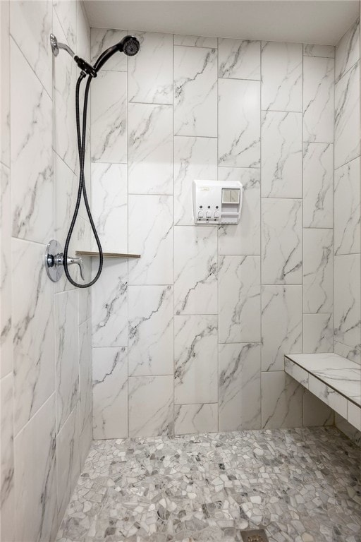 bathroom with a tile shower