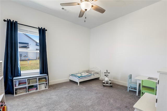 recreation room with ceiling fan, carpet, and plenty of natural light