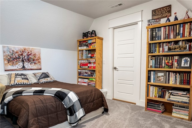 carpeted bedroom with lofted ceiling