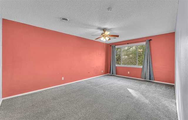 carpeted spare room with a textured ceiling and ceiling fan