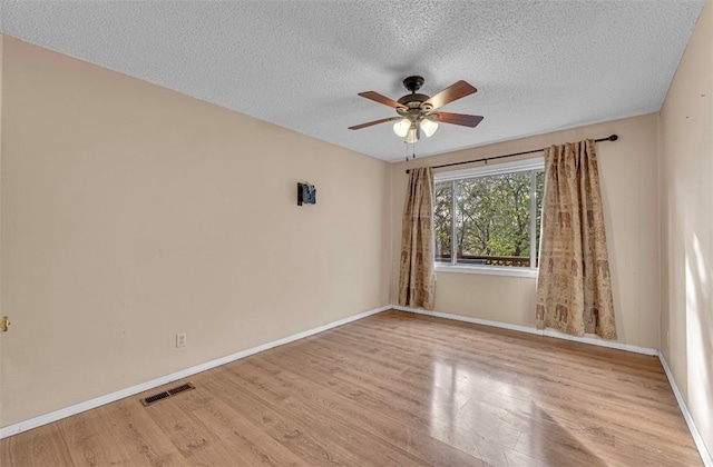 unfurnished room featuring ceiling fan, a textured ceiling, and light hardwood / wood-style flooring