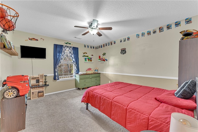 carpeted bedroom featuring a textured ceiling and ceiling fan