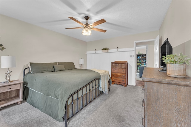 carpeted bedroom with a textured ceiling and ceiling fan