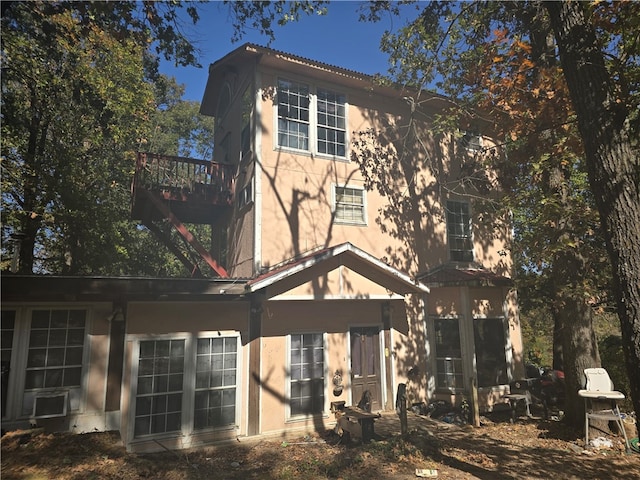 back of property with a balcony