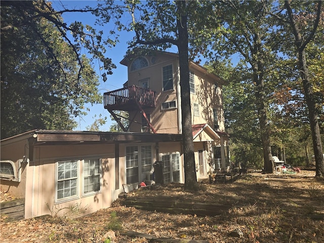 rear view of property featuring a balcony