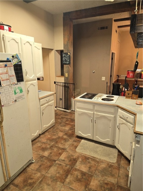 kitchen featuring white cabinetry and white gas stovetop