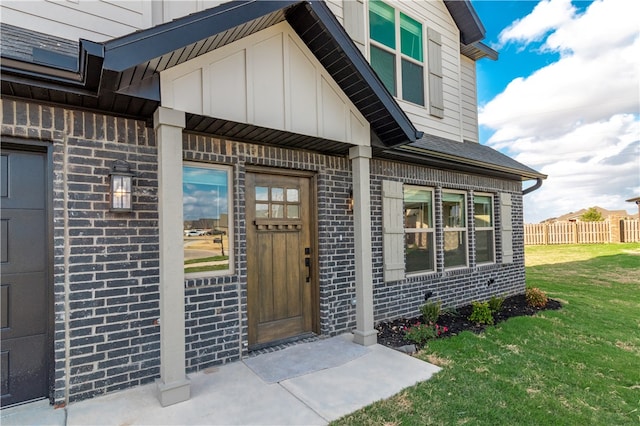 doorway to property featuring a yard