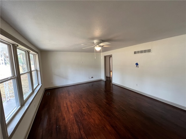 unfurnished room featuring a textured ceiling, dark wood-type flooring, and ceiling fan