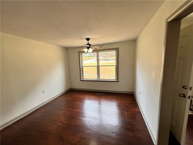 unfurnished room featuring ceiling fan and dark hardwood / wood-style flooring