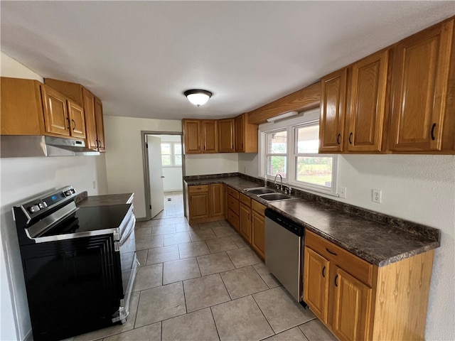 kitchen featuring electric range oven, sink, stainless steel dishwasher, and light tile patterned flooring