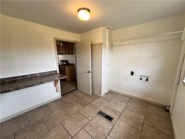 laundry room with hookup for a washing machine and light tile patterned flooring