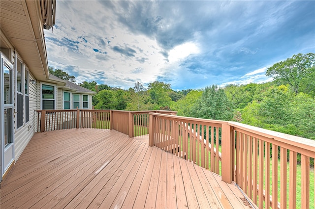 wooden terrace featuring a forest view