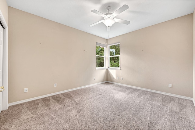 empty room with a ceiling fan, baseboards, and carpet flooring