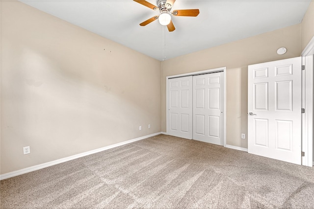 unfurnished bedroom featuring a ceiling fan, a closet, carpet flooring, and baseboards