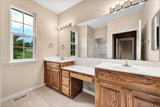 bathroom with visible vents, a shower, baseboards, tile patterned flooring, and vanity