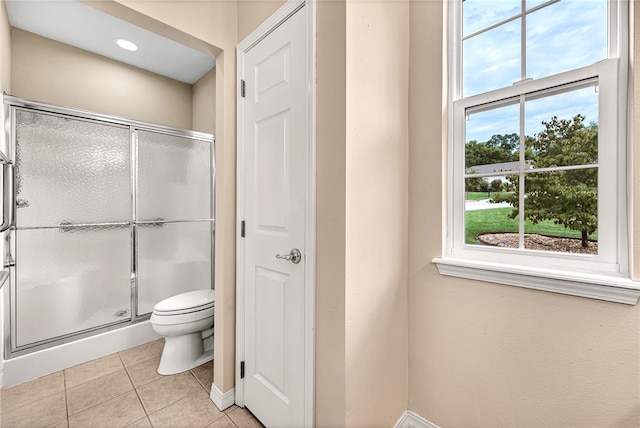 full bathroom with baseboards, a stall shower, toilet, and tile patterned floors