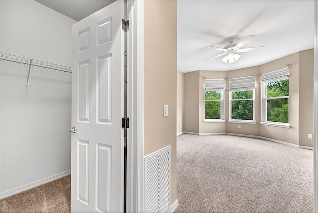 interior space with visible vents, ceiling fan, and baseboards