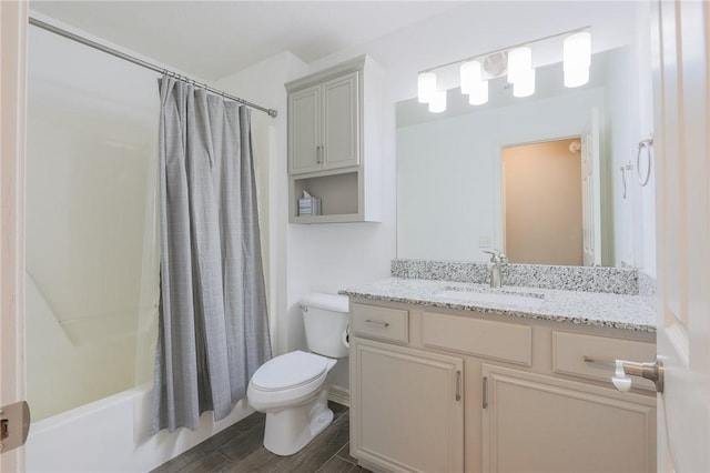 full bathroom featuring toilet, vanity, and shower / bath combo with shower curtain