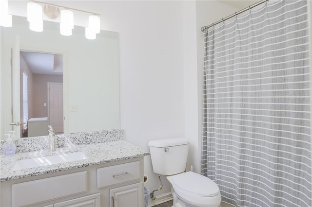 bathroom featuring toilet and vanity