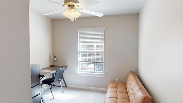 carpeted home office featuring ceiling fan