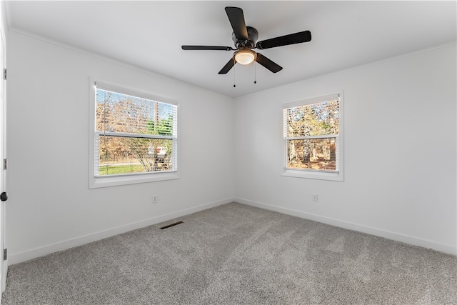 carpeted empty room with ceiling fan and ornamental molding