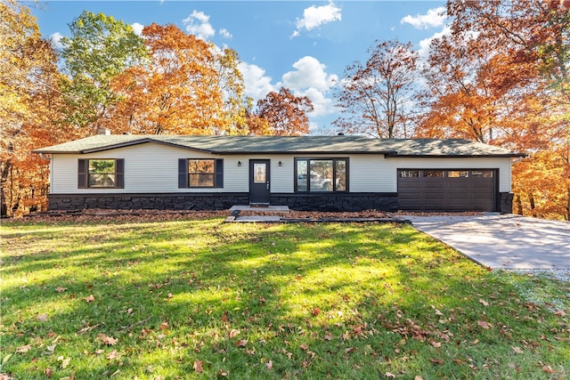 ranch-style house with a garage and a front yard