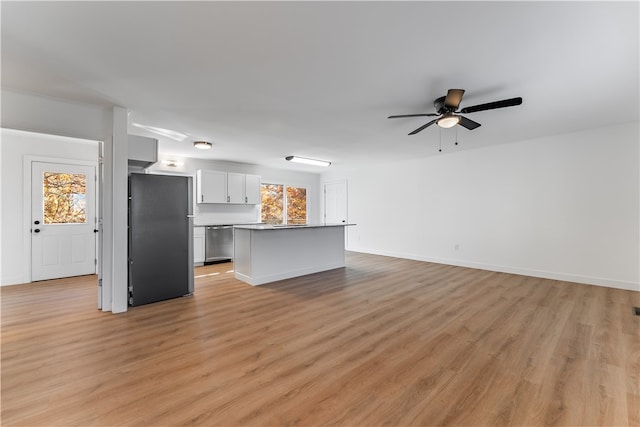 kitchen with a kitchen island, light wood-type flooring, appliances with stainless steel finishes, white cabinets, and ceiling fan