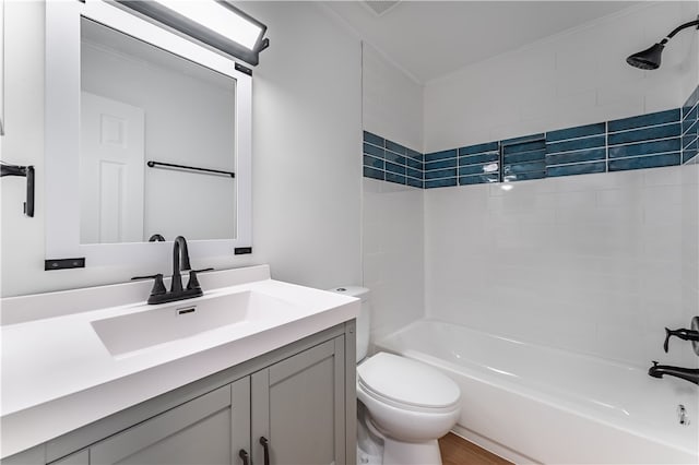 full bathroom featuring wood-type flooring, vanity, crown molding, toilet, and tiled shower / bath combo