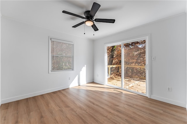 spare room featuring ceiling fan, light wood-type flooring, and ornamental molding