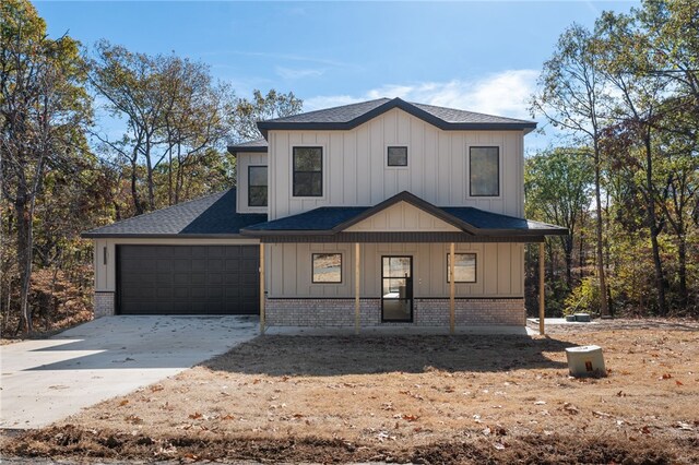 view of front of property featuring a garage and covered porch