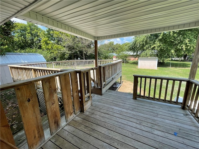 wooden terrace with a yard and a storage shed