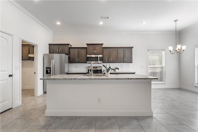 kitchen with an island with sink, dark brown cabinets, light stone counters, and stainless steel appliances