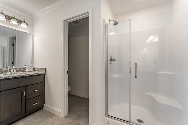 bathroom featuring toilet, tile patterned floors, a shower with door, ornamental molding, and vanity