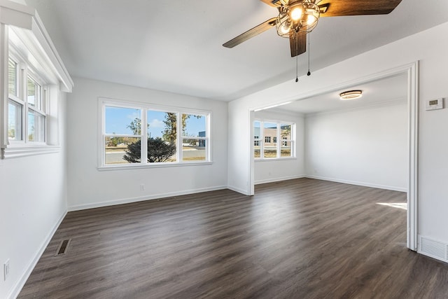 empty room with dark hardwood / wood-style floors and ceiling fan