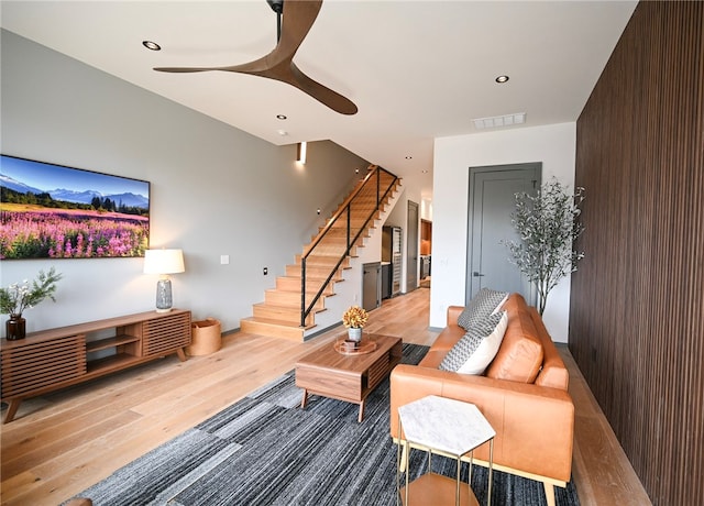 living room featuring wood walls and light hardwood / wood-style floors