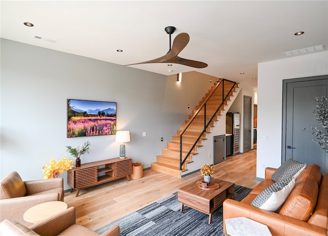 living room featuring hardwood / wood-style flooring and ceiling fan