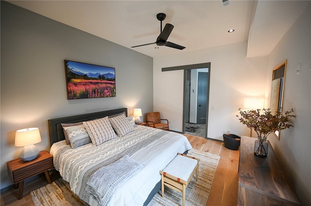 bedroom with hardwood / wood-style flooring and ceiling fan