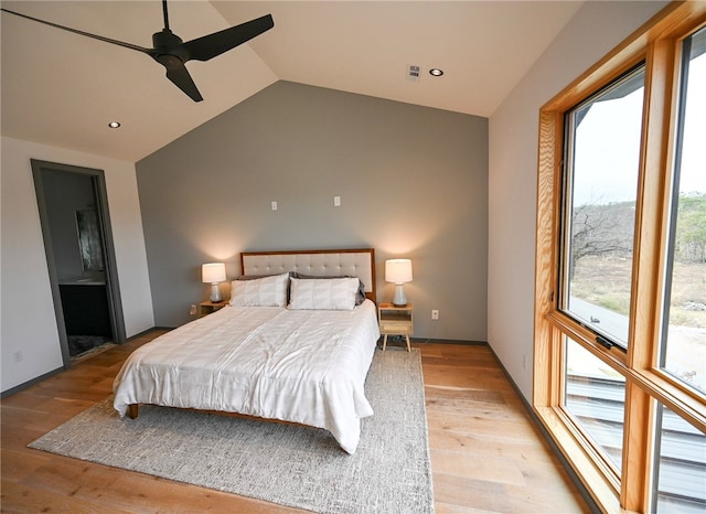 bedroom with light hardwood / wood-style flooring, ceiling fan, and vaulted ceiling