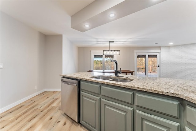 kitchen featuring dishwasher, baseboards, light stone countertops, a sink, and light wood-style floors
