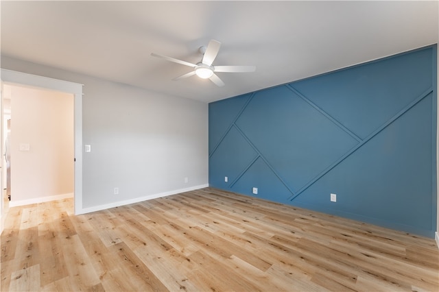 unfurnished room featuring light hardwood / wood-style flooring and ceiling fan