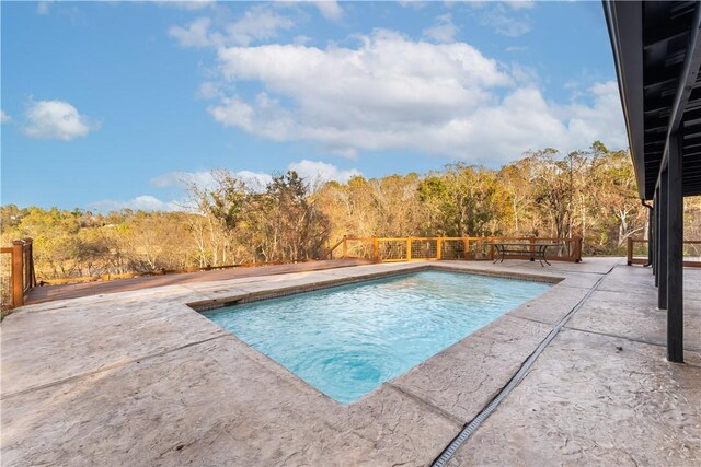 10729 Anzac Dr, Lowell, AR 72745 - view of swimming pool featuring a patio area, a fenced backyard, and a forest view