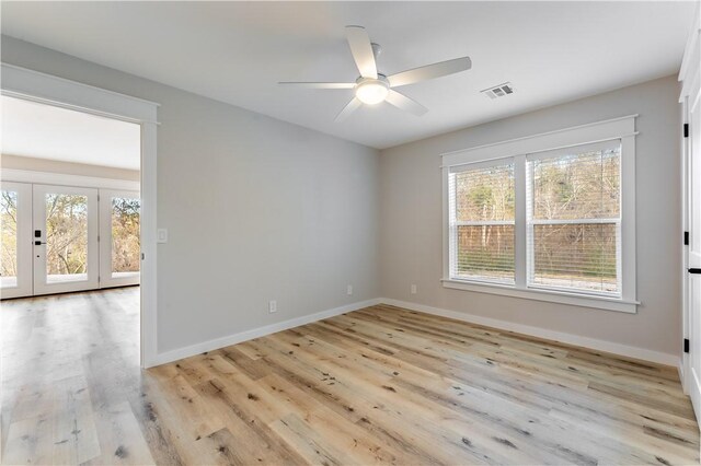 unfurnished room with french doors, plenty of natural light, ceiling fan, and light hardwood / wood-style flooring