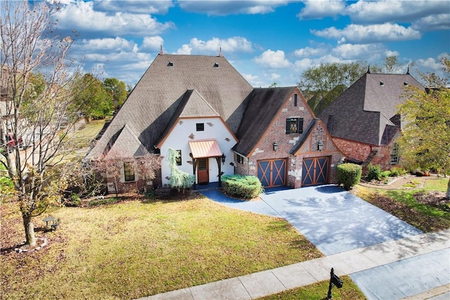 301 SW Beaujolet St, Bentonville, AR 72712 - view of front of property with a front yard, driveway, roof with shingles, and stucco siding